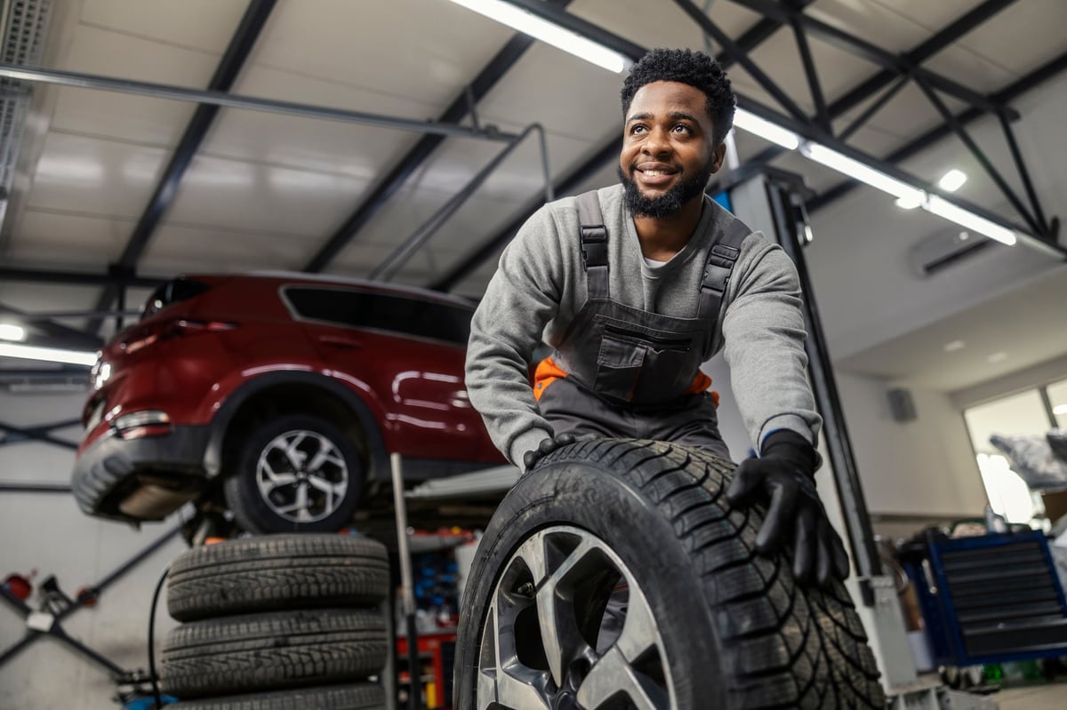 Smiling car technician at an automotive service center